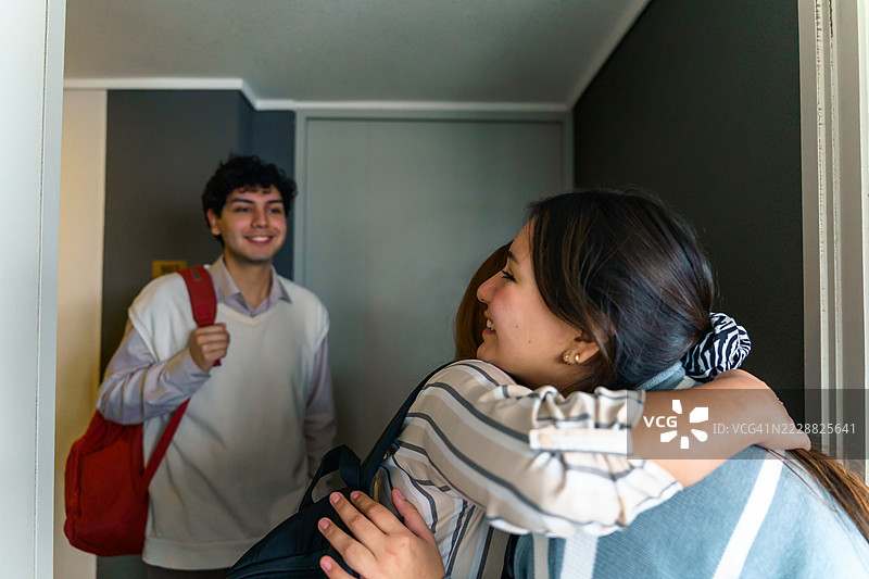 拉丁美洲的朋友们，学生们回到家中相拥而抱。图片素材