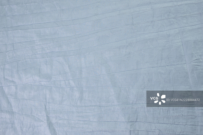 皱褶的蓝色布料背景图片素材