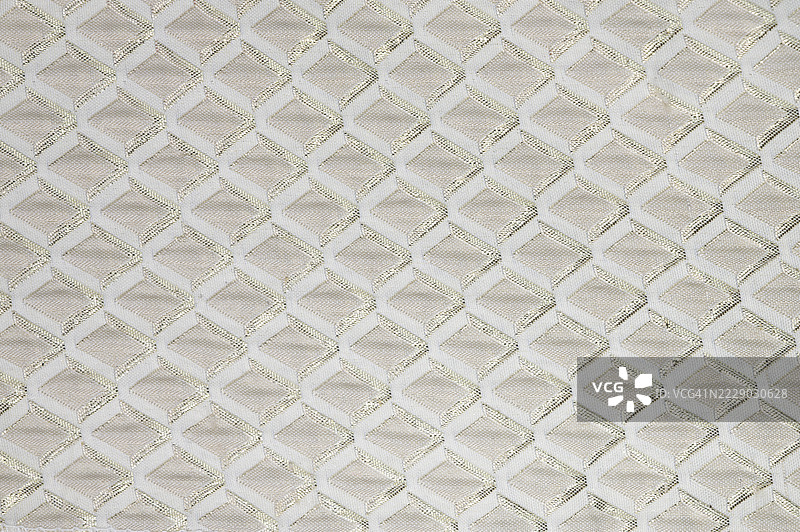 带有菱形图案的白色面料。图片素材