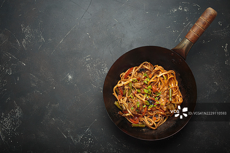 亚洲风味的鸡肉蔬菜炒面，装在黑色碗中图片素材