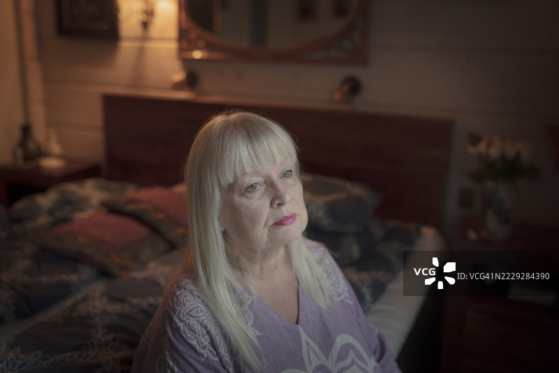 悲伤的老年女性望着窗外 - 股票照片图片素材