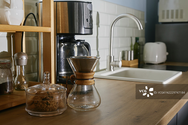 现代厨房内部，早晨有咖啡机和水槽。图片素材