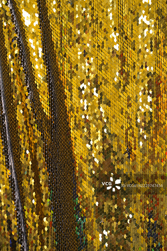 金色亮片面料在聚光灯下闪闪发光图片素材