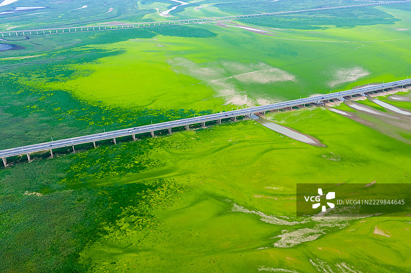 蜿蜒的道路穿过绿色草原图片素材