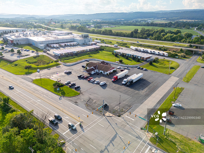 航拍无人机视角下的工厂、住宅和农田，白天，黄金时刻，日落，美国宾夕法尼亚州弗雷德里克斯堡图片素材