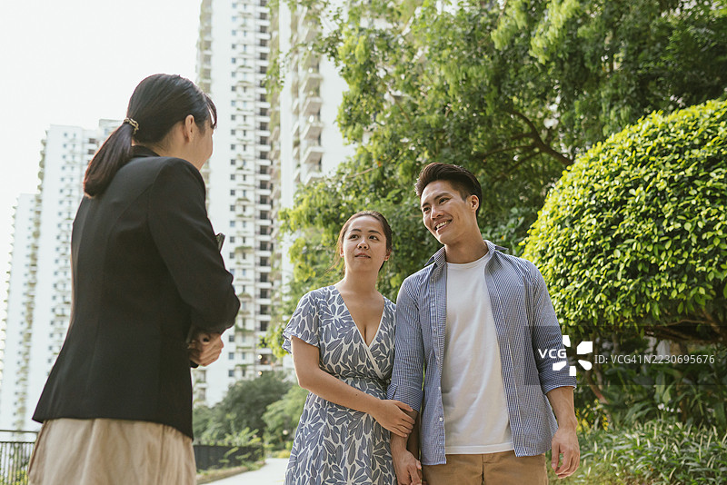 年轻的亚洲夫妇与房地产经纪人会面，进行房屋参观图片素材