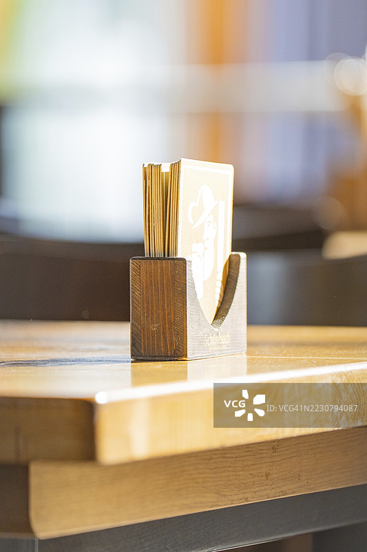 餐厅的阳光明媚的木桌上放着一个卡片夹，位于德国博布林根的Schönbuch酿酒厂图片素材