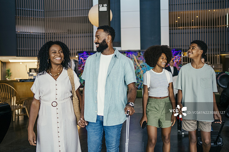 一家人度假到达酒店大堂图片素材