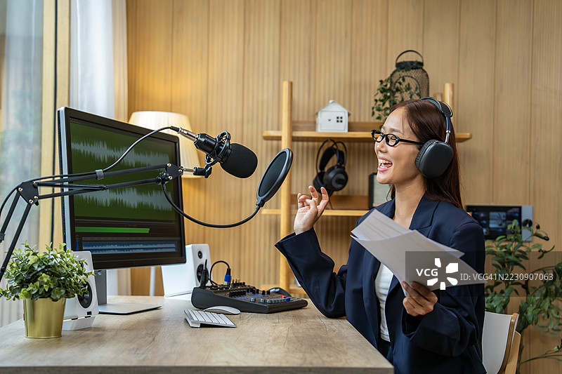 年轻的亚洲女性在她的家庭工作室录制播客图片素材