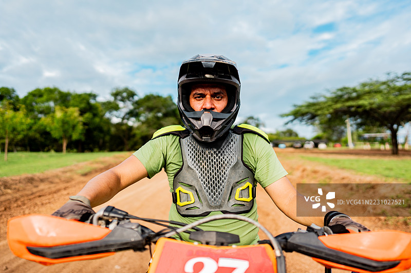 摩托越野车手在赛道上骑着越野摩托车的肖像图片素材