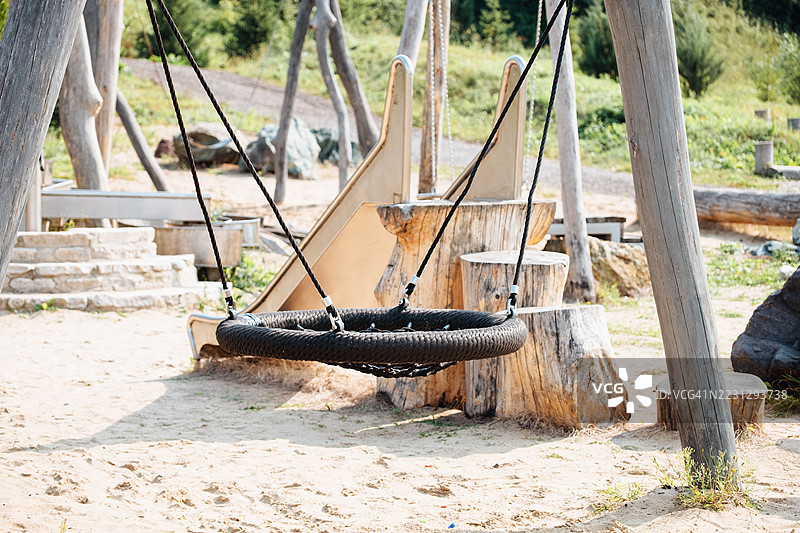 空荡荡的游乐场，沙地上的圆形秋千 - 吊床，留白空间图片素材