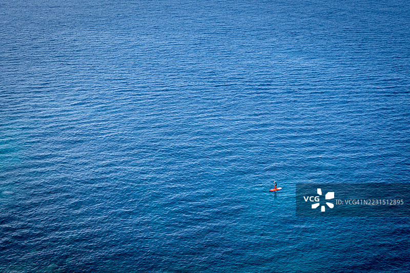 孤独的划水者在广阔的海洋上图片素材