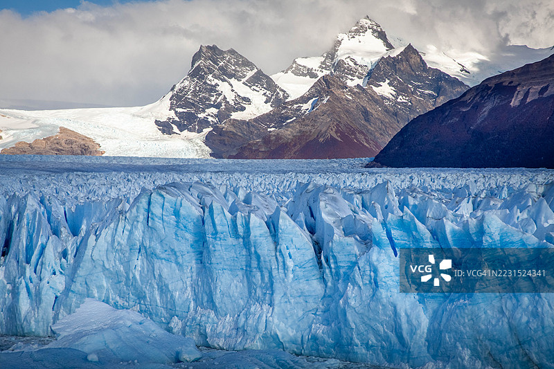 雄伟的雪山和冰川在戏剧性的天空下，阿根廷阿根廷湖图片素材