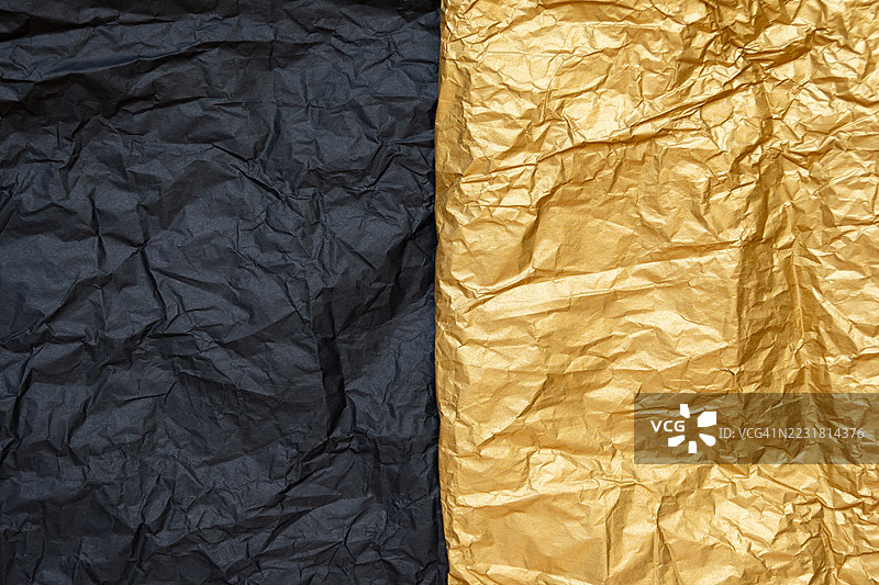皱褶的黑色和金色纹理纸背景图片素材