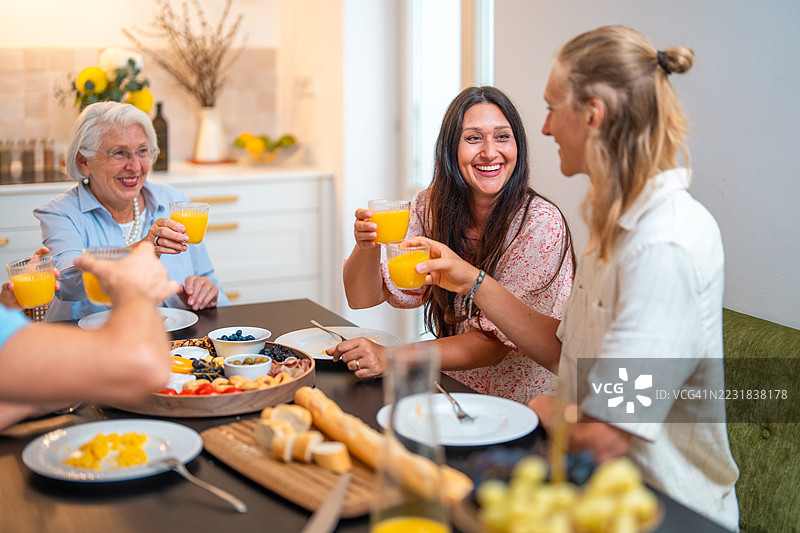 多民族家庭在家享用新鲜果汁早餐图片素材