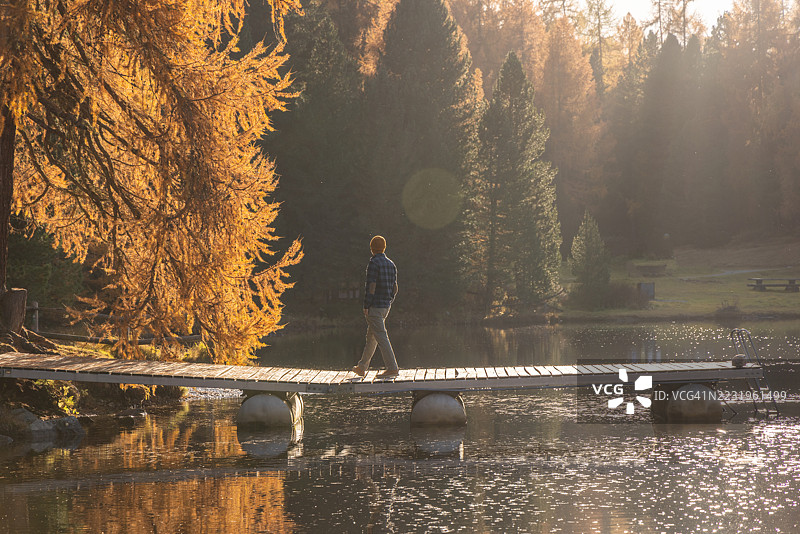 男人在湖上桥上行走图片素材