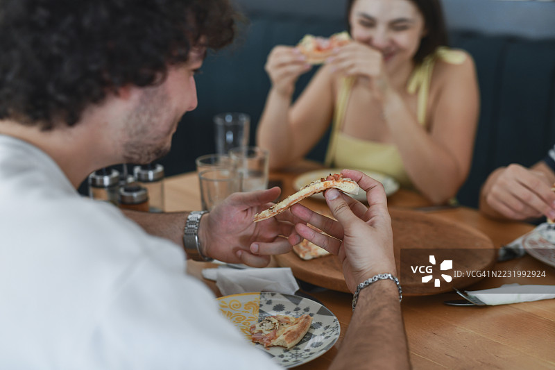 男人即将咬入美味披萨片的特写镜头图片素材