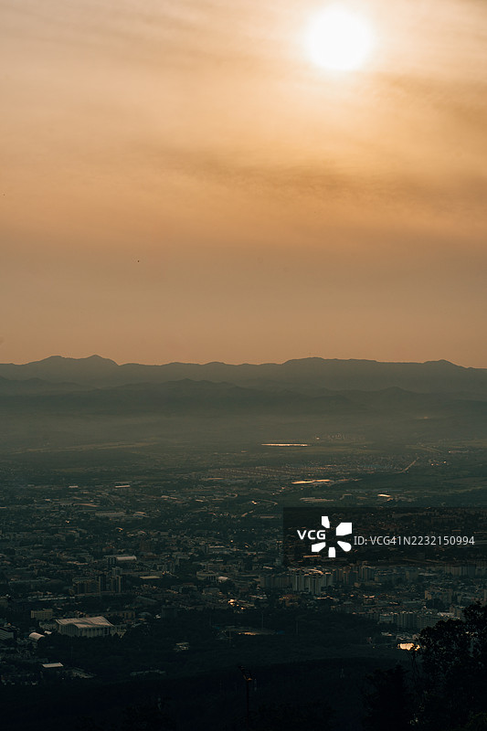 夕阳下的南萨哈林斯克城市景观，背景是山脉。图片素材