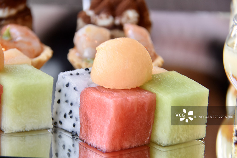 色彩缤纷的水果甜点放在反光表面上图片素材