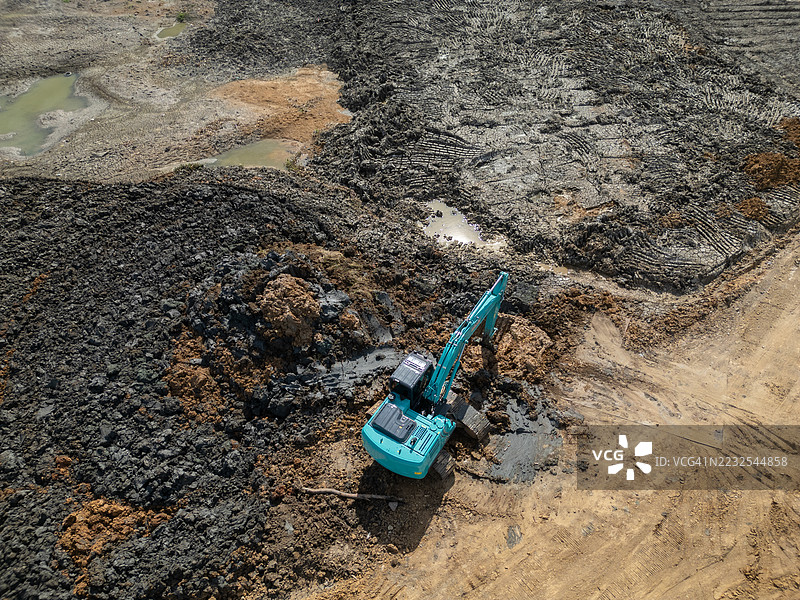 孤立土壤田地中的单台挖掘机挖掘 - 俯视图图片素材