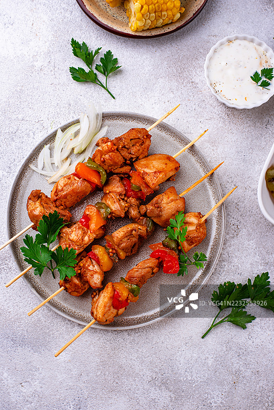 盘子上的烤鸡肉串和蔬菜图片素材