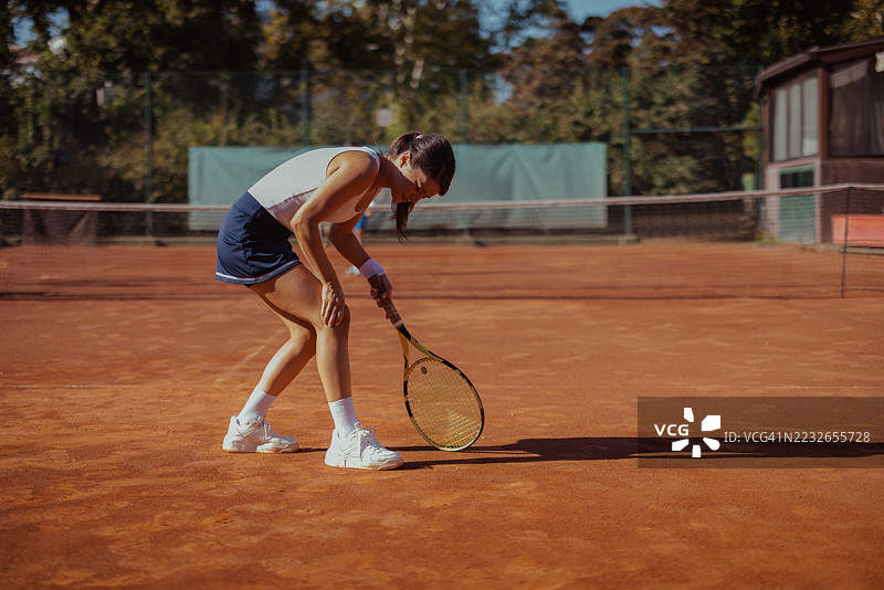 户外女性网球运动员膝盖拉伤概念图片素材