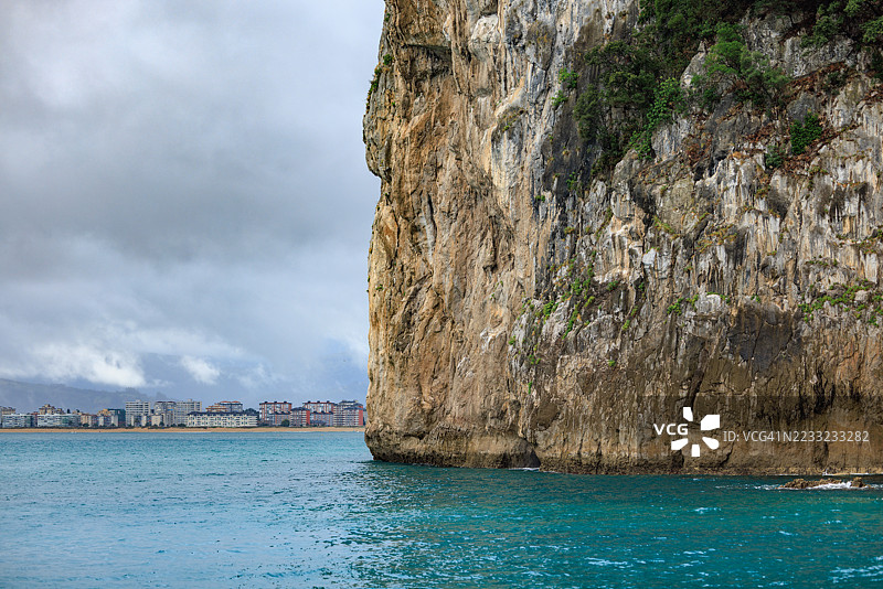 高耸的海岸悬崖与远处的拉雷多天际线图片素材