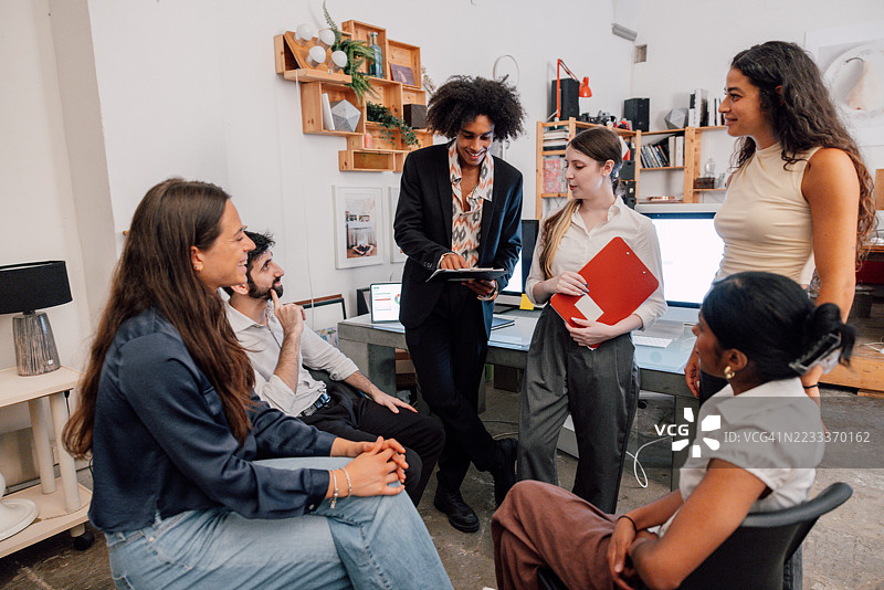 友好的初创公司办公室中的协作对话图片素材