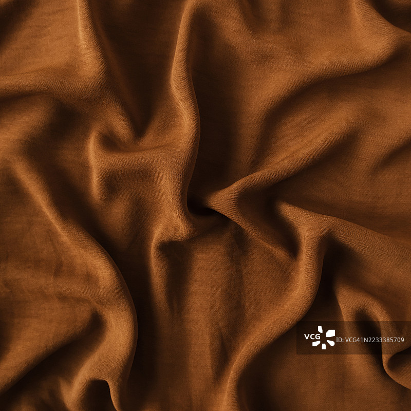 褶皱的棕色布料特写图片素材
