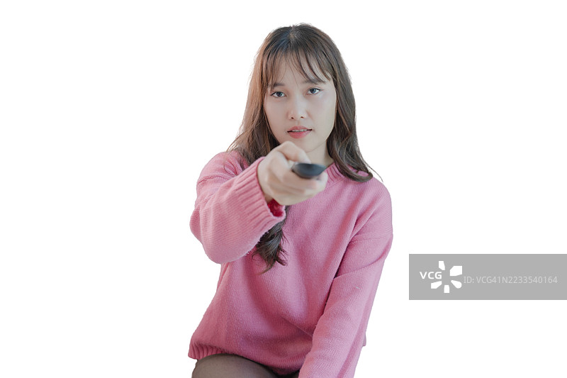一位穿着粉色毛衣的女性正在拿着遥控器图片素材