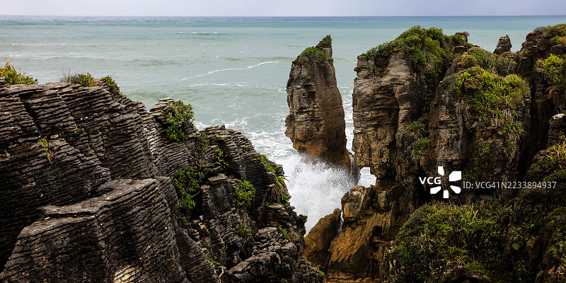 戏剧性的海岸岩石 formations 与拍打的海浪图片素材