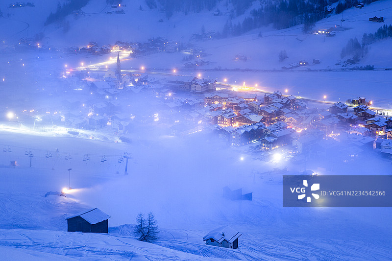 黄昏时分，雾中的利维尼奥雪山村庄图片素材