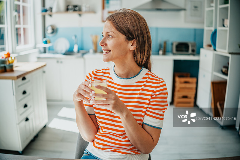 在阳光明媚的下午，在明亮的家居厨房享用清爽的饮品图片素材