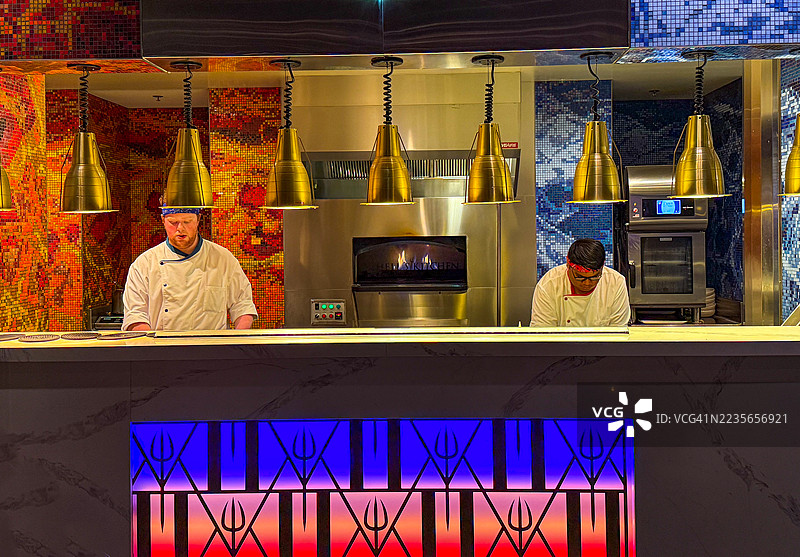 在戈登·拉姆齐地狱厨房餐厅的开放式厨房中工作的厨师们图片素材