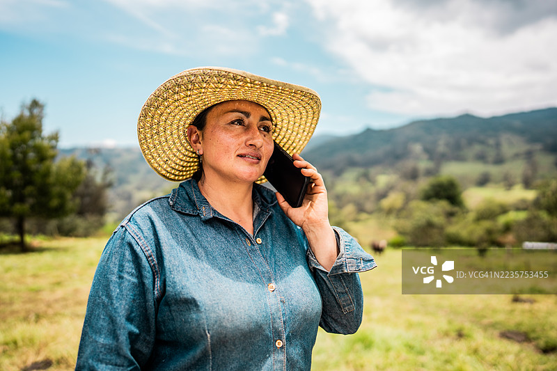 哥伦比亚昆迪纳马卡农场里一位农妇正在打电话图片素材