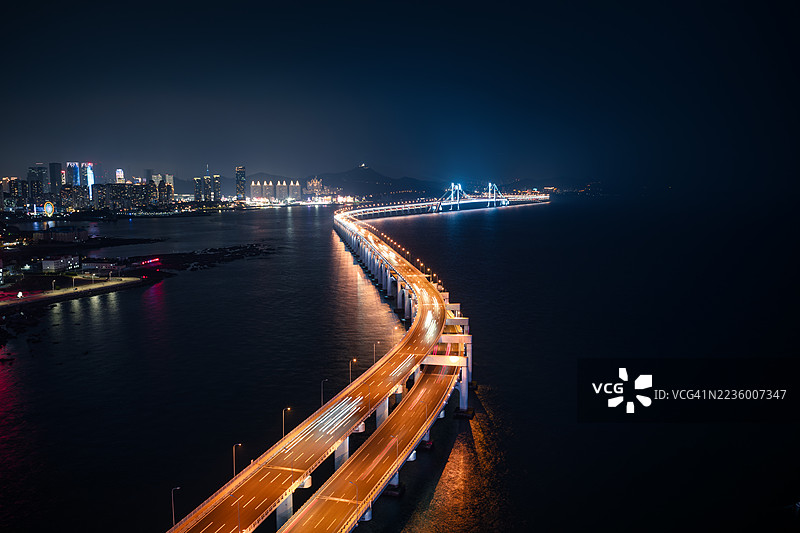 现代桥梁在夜间跨越海洋图片素材