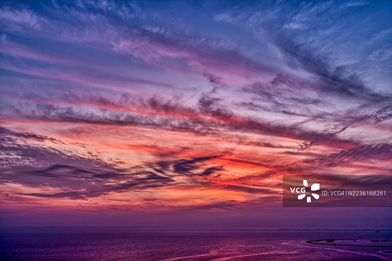 马来西亚丹绒托孔的海洋上空绚丽的日落天空，伴随着戏剧性的云彩和多彩的倒影，坦戈巴哈路。图片素材