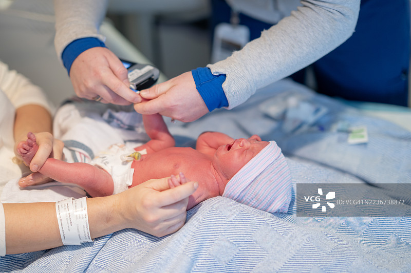 出生后在医院护理的婴儿与医疗团队图片素材