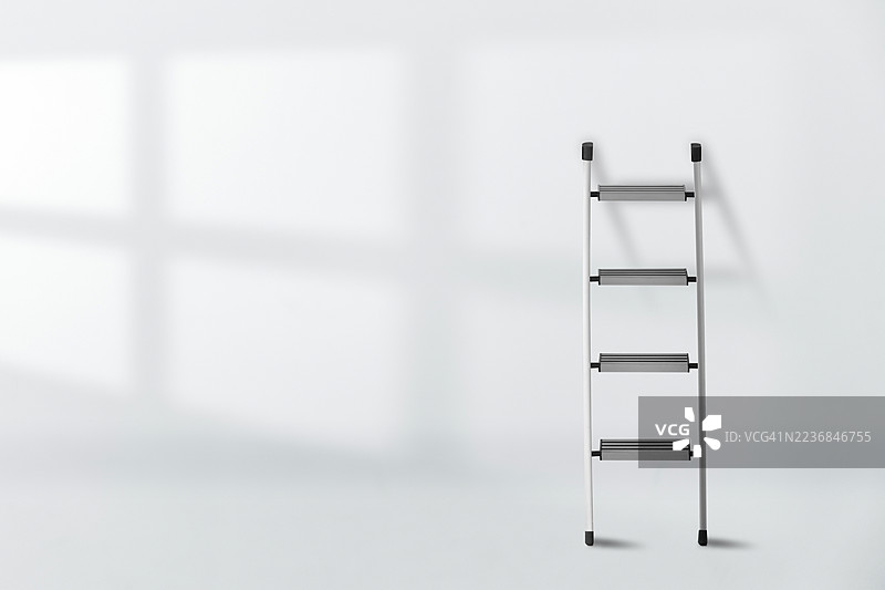 白色墙壁上的铝制折叠梯及其窗户阴影图片素材