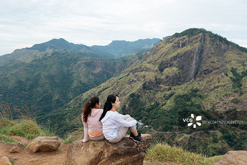 亚洲女性在斯里兰卡小亚当峰顶欣赏风景图片素材