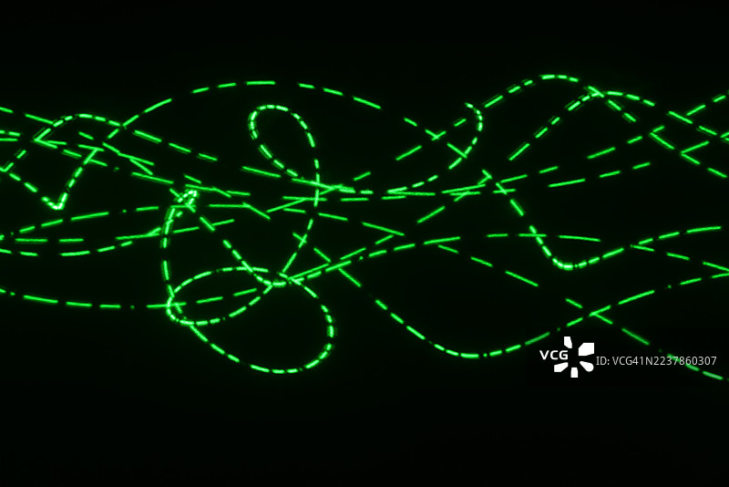 激光灯发光的螺旋仪图案——一个由完美几何曲线和循环组成的复杂网络。图片素材