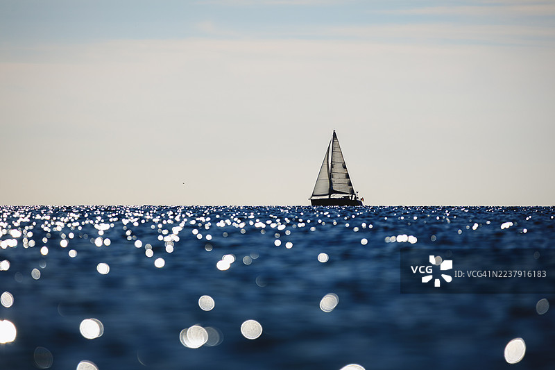 帆船在阳光明媚的日子里穿越闪闪发光的波罗的海图片素材
