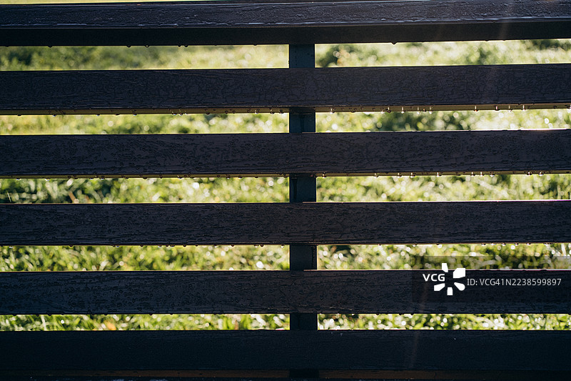 带露珠和晨光的条纹木栅栏图片素材