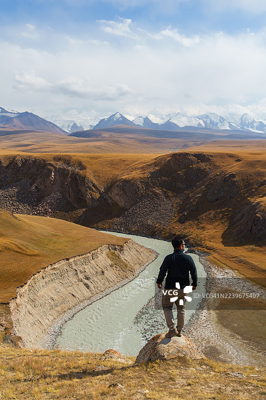 一名男子在秋季探索吉尔吉斯斯坦的萨雷贾兹山谷图片素材