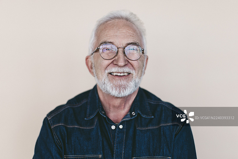 戴眼镜的年长男子，背景色彩鲜艳图片素材