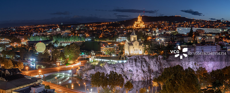 暮色中的第比利斯老城：城市灯火点亮历史建筑和姆特克瓦里河。图片素材