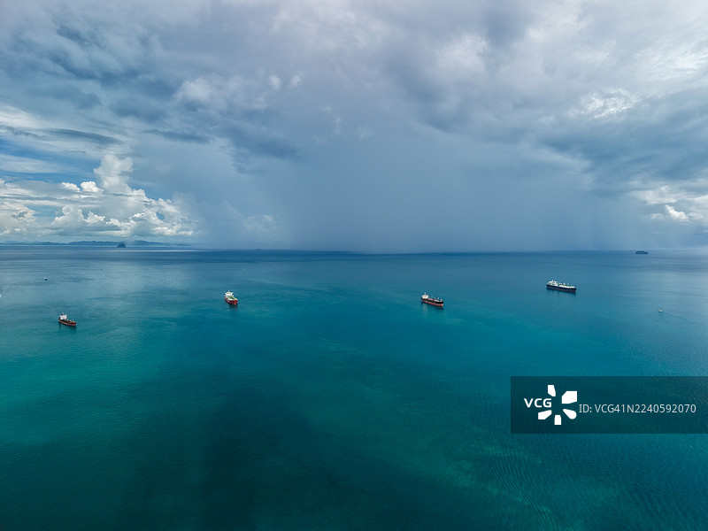 带有岛屿和船只的热带海洋上空的风暴天空图片素材