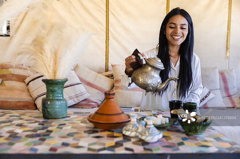 摩洛哥茶在撒哈拉沙漠豪华帐篷内斟茶图片素材