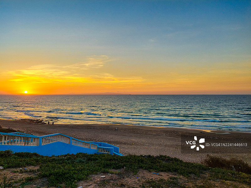 阿尔及利亚莫斯塔加纳姆，海边日落，沙滩和蓝色楼梯，通往海边，色彩鲜艳图片素材