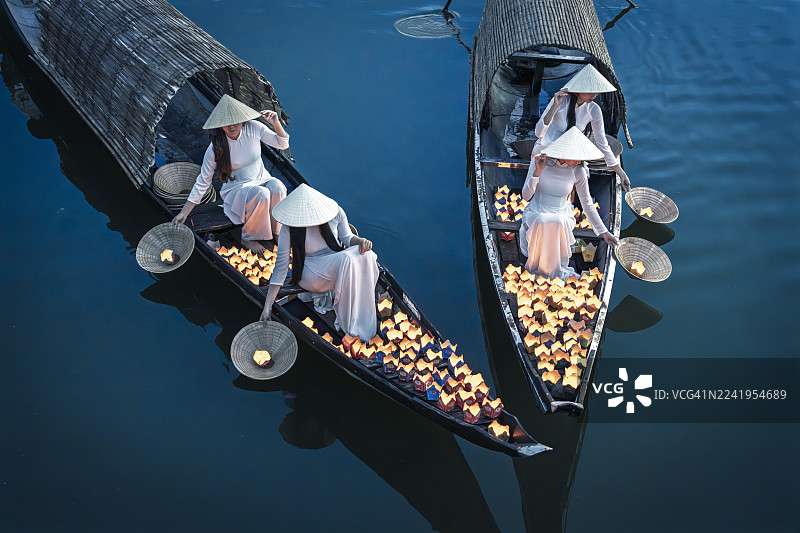 越南妇女在越南顺化香江的黄昏时分，从船上售卖灯笼图片素材